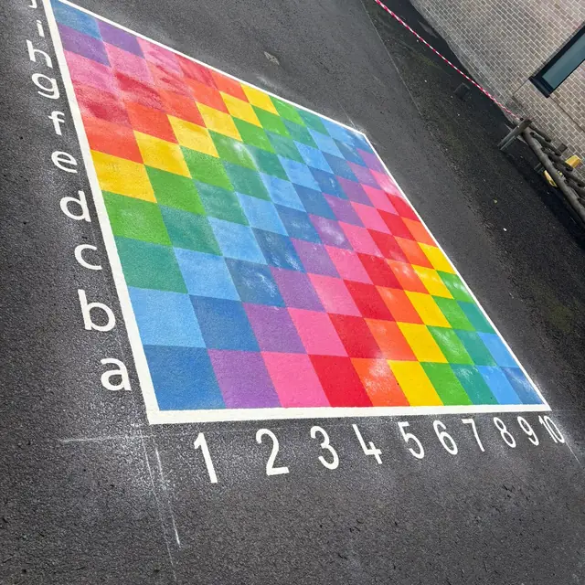A rainbow grid with letters a to j and numbers 1 to 10 along its edges
